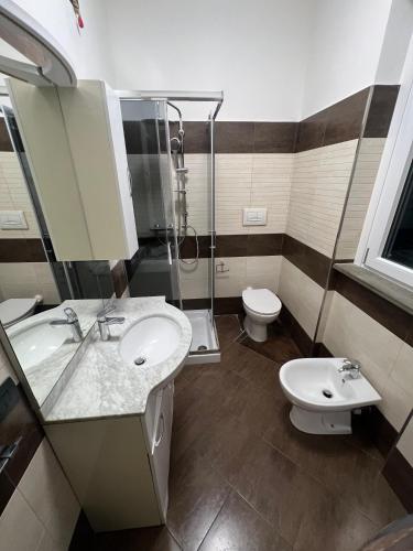 a bathroom with a sink and a shower and a toilet at La Dimora del Lago d'Iseo in Sarnico