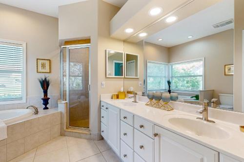 a bathroom with two sinks and a shower at Golfer's Oasis w/ Pool in Black Diamond Ranch! in Lecanto