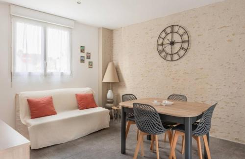 a living room with a couch and a table at Gîte Le Clos Controis in Le Controis En Sologne