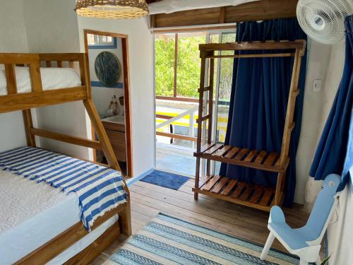 a bedroom with two bunk beds and a window at Mio Mio Beach in Barú