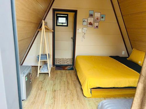 a bedroom with a bed in a tiny house at Mia's Homestay in Quang Ninh