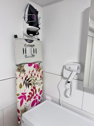 a toilet in a bathroom with a machine on top of it at Weserblick Hafen-Haus-Bremen in Bremen