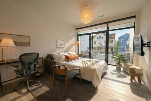 a bedroom with a bed and a desk and a chair at East Side Luxury 1BR Apt - Near Brady St with Balcony and Lounge - Sleeps 4 in Milwaukee
