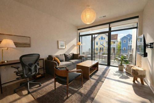 a living room with a couch and a chair at East Side Luxury 1BR Apt - Near Brady St with Balcony and Lounge - Sleeps 4 in Milwaukee