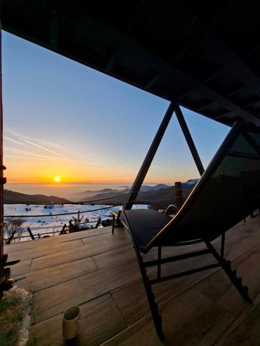 a hammock on a deck watching the sunset at SUNSET Villa PONIKVA in Kočani