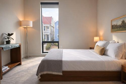 a bedroom with a large bed and a large window at East Side Luxury 1BR Apt - Near Brady St with Balcony and Lounge - Sleeps 4 in Milwaukee
