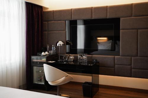 a hotel room with a desk and a chair at 11 Mirrors Design Hotel in Kyiv