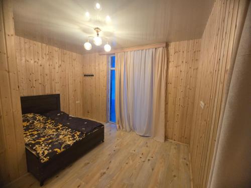 an empty bedroom with a bed and a window at goderdzi booking in Goderdzi