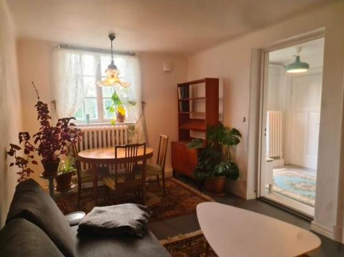 a living room with a couch and a table at Nice and cosy flat in Molkom