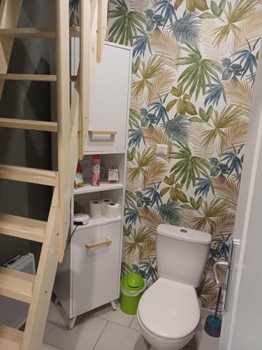 a small bathroom with a toilet and a staircase at La Marceline Gîte avec piscine près de Lascaux IV in Aubas