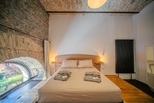 a bedroom with a bed with two trays on it at Cosy Moods - OldTown in Trieste