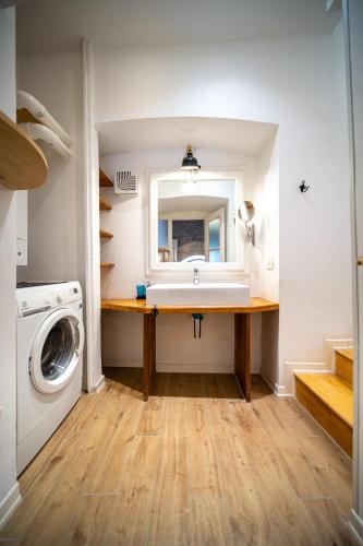 a bathroom with a sink and a washing machine at Cosy Moods - OldTown in Trieste