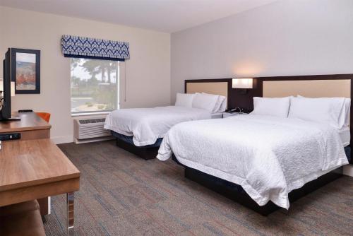 a hotel room with two beds and a window at Hampton Inn Benson in Benson