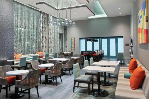 a dining room with tables and chairs and windows at Hampton Inn & Suites Atlanta Buckhead Place in Atlanta