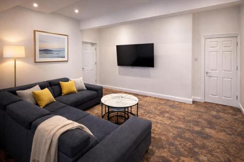 a living room with a couch and a tv at The Miles Arms Hotel in Avonmouth