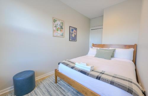 a small bedroom with a bed and a blue stool at Urban Chic South End Studio in Boston