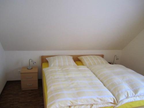 two beds sitting next to each other in a bedroom at Hotel Café Wahlde Restaurant in Neuenkirchen-Vörden