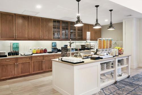 a large kitchen with wooden cabinets and a counter at Homewood Suites by Hilton Providence Downtown in Providence