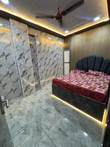 a room with a bed and a chair in it at Lari Guest House in Gorakhpur