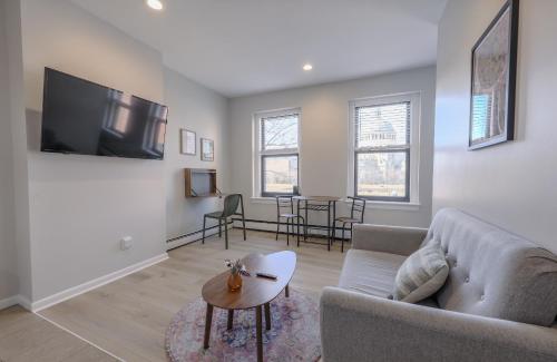 a living room with a couch and a tv at Urban Chic South End Studio in Boston