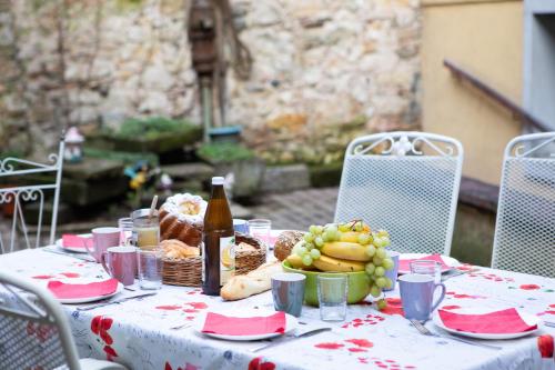 a table with a bunch of food and a bottle of beer at Gîte chez Suzannala in Ingersheim