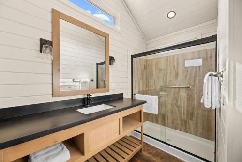 a bathroom with a sink and a shower at Zion Vacation Cabins in Virgin