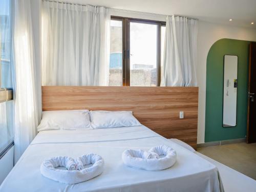 a bedroom with a bed with two towels on it at Porto de Galinhas PORTO EXCLUSIVE BY AFT in Porto De Galinhas