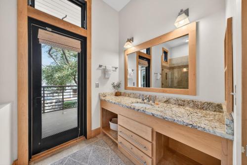 a bathroom with a sink and a mirror at Brighton Cottage in Rosemary Beach