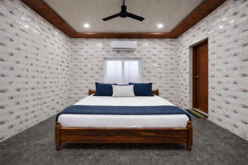 a bedroom with a bed and a ceiling fan at Lakshmi Divya Guest house in Pedda Ahobilam