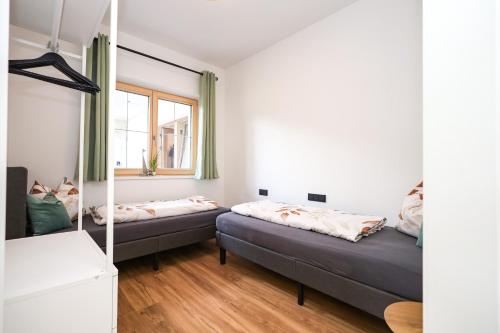 a bedroom with two beds and a window at Apartment Alpbachtraum in Alpbach