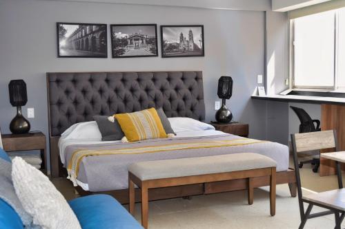 a bedroom with a large bed with a tufted headboard at Centro Histórico Hermosos Departamentos, Casas Freda in San Luis Potosí