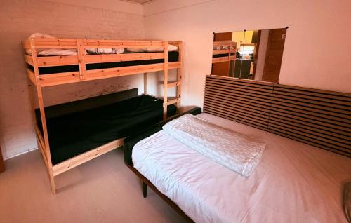 a bedroom with two bunk beds and a mirror at Family room in centrum 300m to Lego House and walking street in Billund