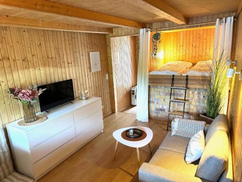 a small living room with a bed and a couch at Bootshaus, Mirow in Mirow