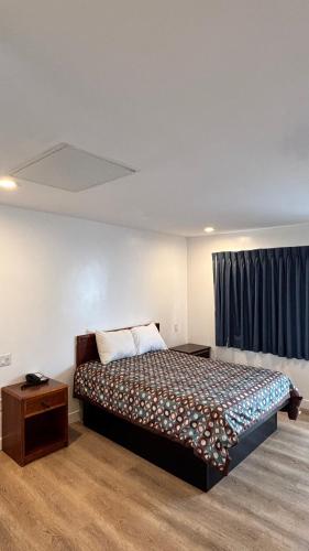 a bedroom with a large bed and a window at Budget inn Whittier in Whittier