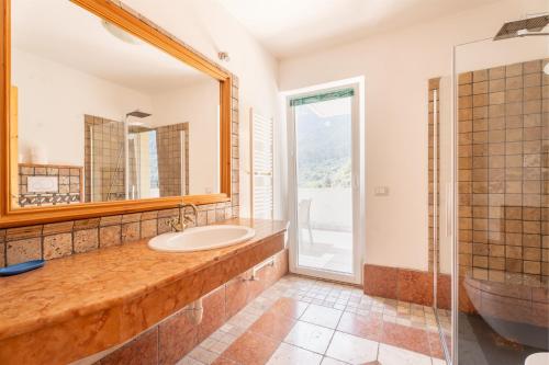 a bathroom with a sink and a mirror at Villa Dream alla Beppa in Tenno