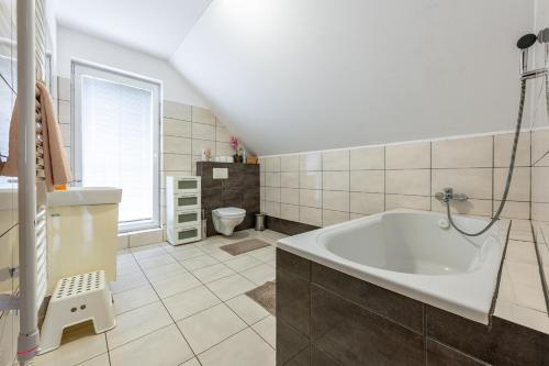 a bathroom with a tub and a sink at Chata Majocka Martin Strane, Ferrata in Martin