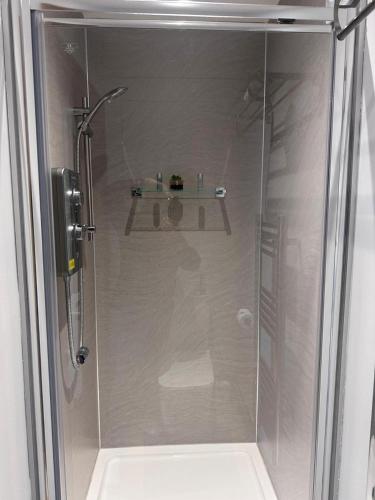 a shower with a glass door in a bathroom at Beautiful 1-Bed studio in Penrith in Penrith