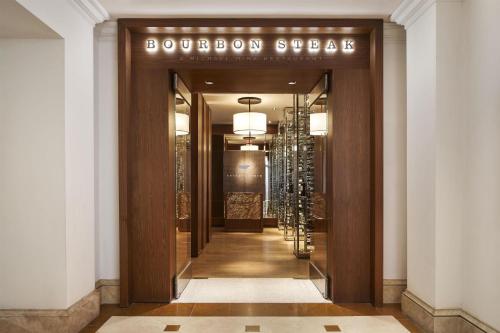 a hallway with a door with a sign that reads bourbon store at Waldorf Astoria Monarch Beach Resort & Club in Dana Point