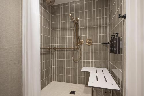 a bathroom with a shower with a sink at The Scottsdale Resort & Spa, Curio Collection by Hilton in Scottsdale