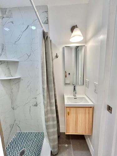 a bathroom with a sink and a shower at 241- Convenient City Stay in Hoboken
