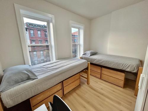 a room with two beds and a window at 241- Convenient City Stay in Hoboken