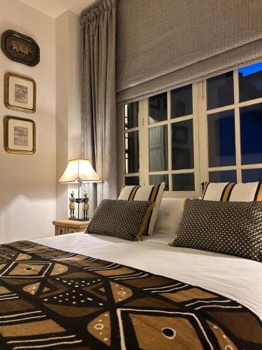 a bedroom with a bed with a large window at Casona de Santa Ana in Cuevas Bajas