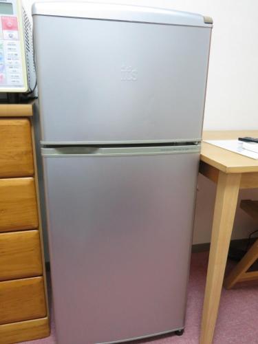 a white refrigerator in a kitchen next to a desk at Belaire Ogata - Vacation STAY 32397v in Sanuki