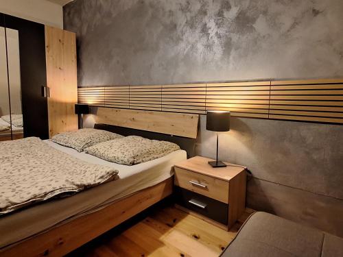 a bedroom with two beds and a lamp on a night stand at Apartmán CENTRAL, near the center, self check in 24 h, free parking in Banská Bystrica