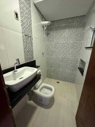 a bathroom with a sink and a toilet at Casa Canto do Rio in Socorro