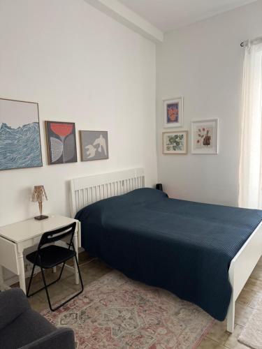 a bedroom with a bed and a table and a chair at lungomare portoturistico in Chiavari