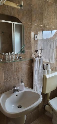 a bathroom with a sink and a mirror at Lukács Ház in Bük