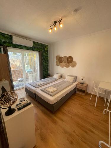 a bedroom with a bed and a large window at MaNo Apartman Siófok in Siófok