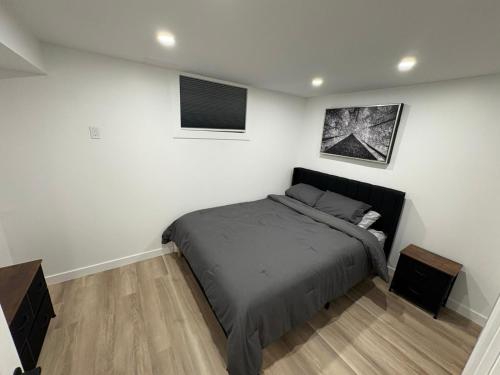 a bedroom with a bed and two pictures on the wall at Private Suite Jones Lake- West Moncton in Moncton