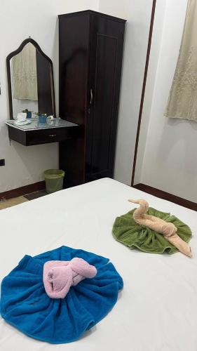 two towels sitting on a bed in a room at Bayt Zaina Nile View in Aswan